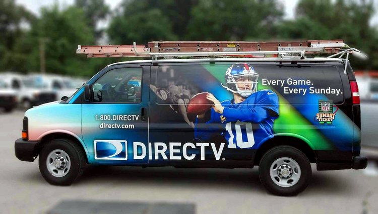 DIRECTV service van with a ladder rack, wrapped in a blue and green gradient featuring an NFL Sunday Ticket quarterback graphic across the rear panel.